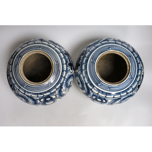 414 - A pair of Chinese blue and white Shuangxi jars and cover, 25cms high