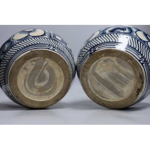 414 - A pair of Chinese blue and white Shuangxi jars and cover, 25cms high