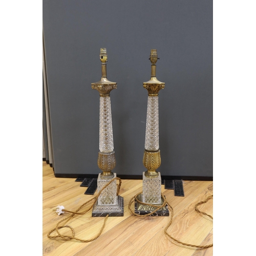 421 - A pair of gilt brass and glass lamps with shades, 71cms high including light fitting