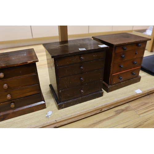 423 - Three miniature four drawer collector's chests, tallest 33cms high