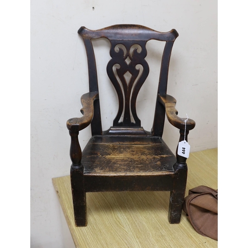 444 - An 18th century pine and fruitwood child's elbow chair, 61cms high (feet spliced)