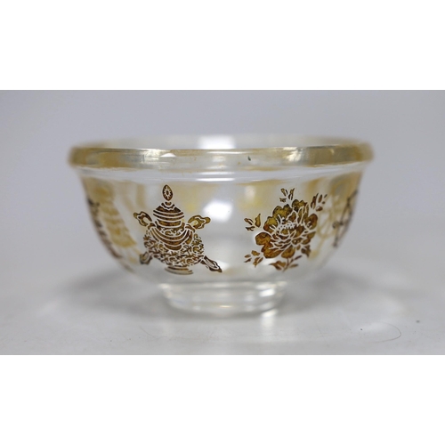 472 - A Tibetan glass dish with gilt interior decoration. 9cm diameter