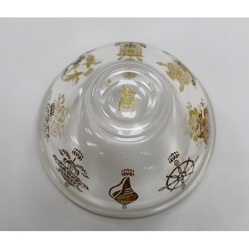 472 - A Tibetan glass dish with gilt interior decoration. 9cm diameter