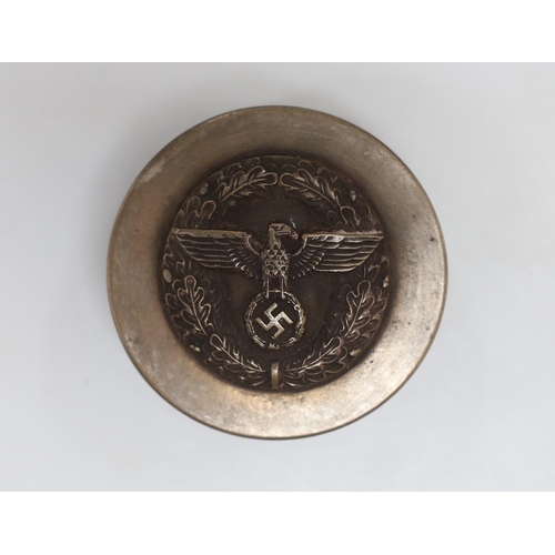 488 - A composition and metal snuff box, with Third Reich insignia. 7cm diameter