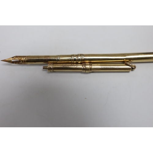 498 - A George V 9ct gold dip pen by Sampson Mordan & Co, 12.4cm, 6.8 grams and a Sampson Mordan & Co yell... 