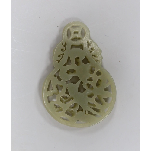 513 - A Chinese celadon jade reticulated pendant. 7cm tall