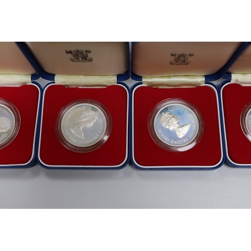 521 - Eight Royal Mint Commonwealth commemorative proof silver crowns