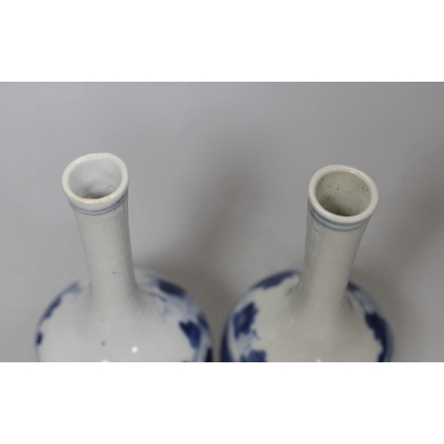 554 - A pair of 19th century Chinese blue and white bottle vases, 16cm