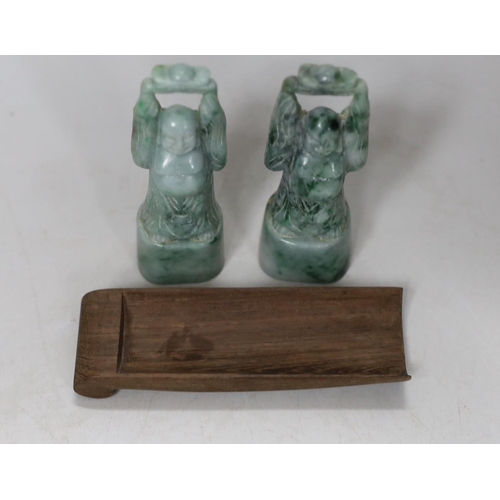 555 - A pair of jadeite figural carvings and a gouged wood pan rest