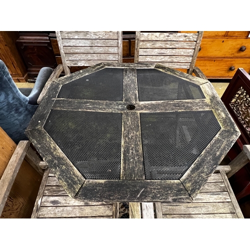 57 - An octagonal weathered teak and mesh garden table, length 103cm, height 74cm together with four teak... 