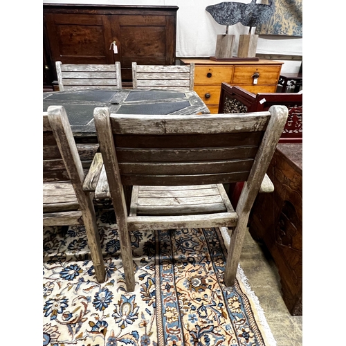 57 - An octagonal weathered teak and mesh garden table, length 103cm, height 74cm together with four teak... 