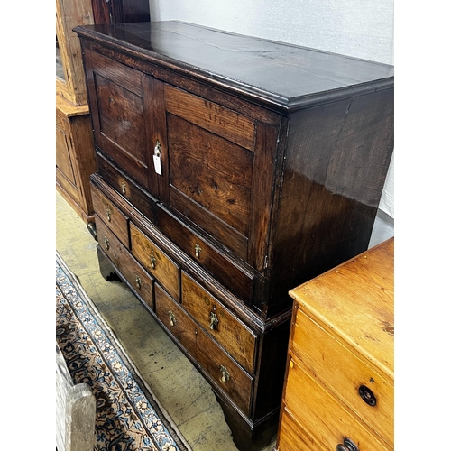 7 - An 18th century oak low press cupboard, length 136cm, depth 53cm, height 137cm