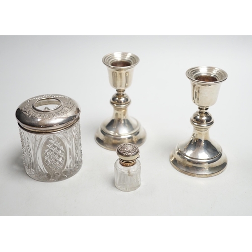 801 - A pair of 1930's silver mounted dwarf candlesticks, 10cm, a silver mounted glass hair tidy and a sce... 