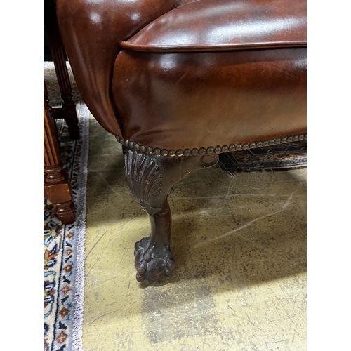 84 - A George II style studded brown leather wing armchair, width 84cm, depth 86cm, height 108cm