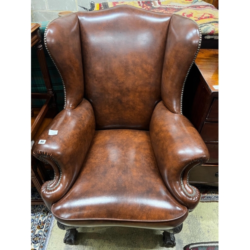 84 - A George II style studded brown leather wing armchair, width 84cm, depth 86cm, height 108cm