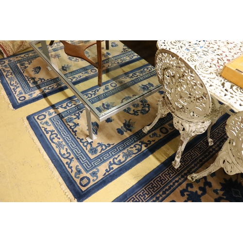 95 - A pair of Chinese beige ground rugs and a similar rug, 174 x 92cm