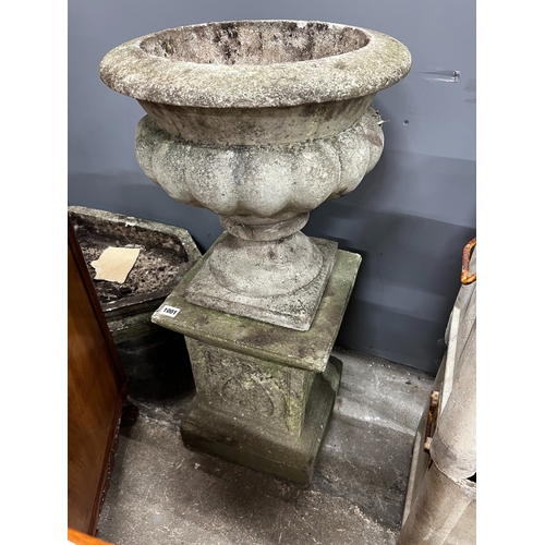 1001 - A circular reconstituted stone garden planter on square plinth, diameter 40cm, height 84cm together ... 