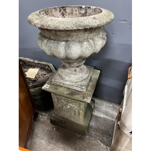 1001 - A circular reconstituted stone garden planter on square plinth, diameter 40cm, height 84cm together ... 