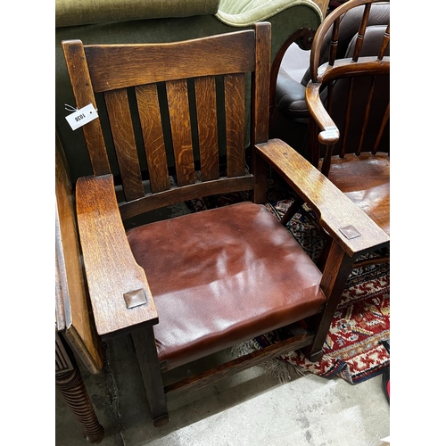 1038 - An early 20th century Stickley oak rocking chair, width 66cm, depth 50cm, height 86cm