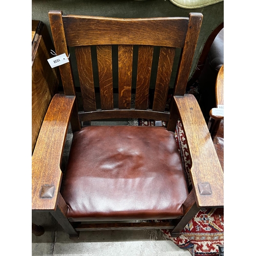 1038 - An early 20th century Stickley oak rocking chair, width 66cm, depth 50cm, height 86cm