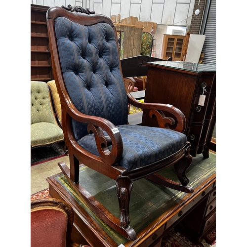 1042 - A Victorian carved mahogany upholstered rocking elbow chair, width 53cm, depth 76cm, height 104cm... 