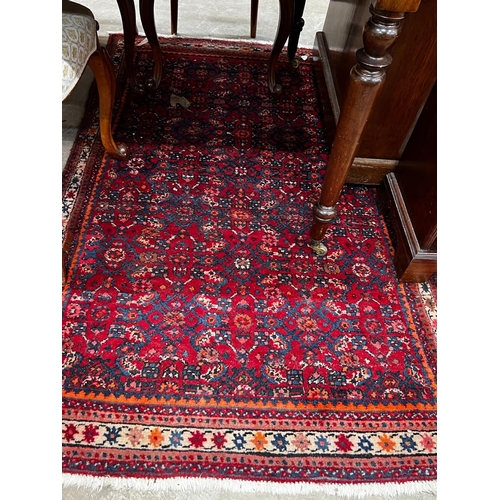 1049 - A North West Persian red ground rug, 164 x 105cm