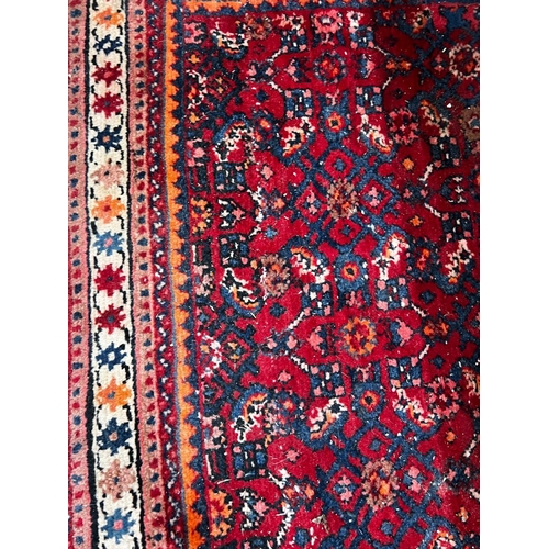 1049 - A North West Persian red ground rug, 164 x 105cm