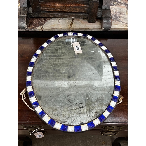 1058 - An oval Irish style wall mirror, width 41cm, height 51cm