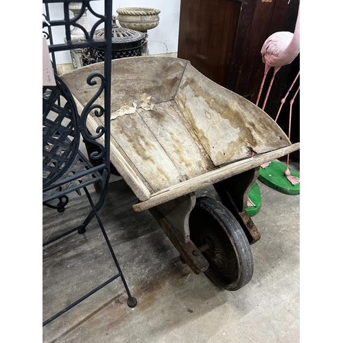 1065 - A rustic wooden wheelbarrow, width 60cm, length 110cm, height 53cm