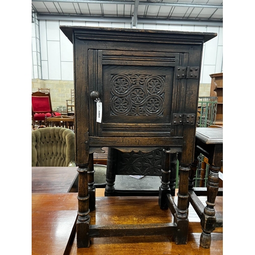 1084 - A small 17th century style carved oak side cabinet, width 53cm, depth 34cm, height 83cm