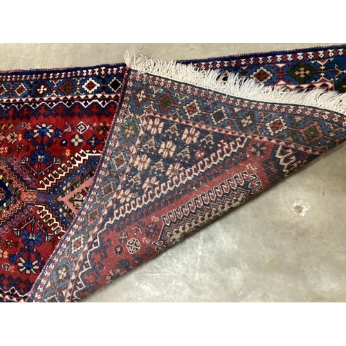 1087 - A Caucasian style red ground runner 200cm x 76cm