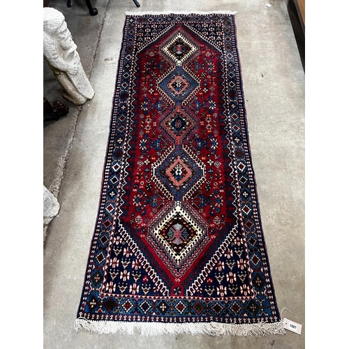 1087 - A Caucasian style red ground runner 200cm x 76cm