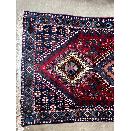 1087 - A Caucasian style red ground runner 200cm x 76cm