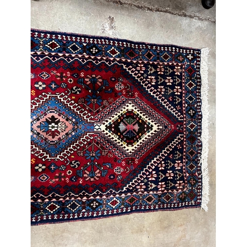 1087 - A Caucasian style red ground runner 200cm x 76cm