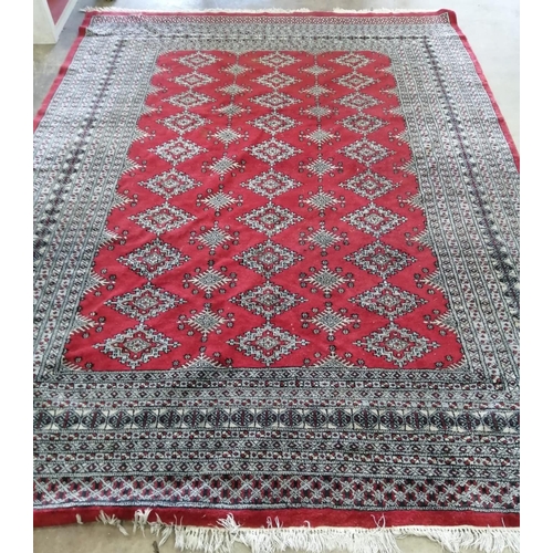 1097 - An Afghan red ground carpet, 290 x 210cm