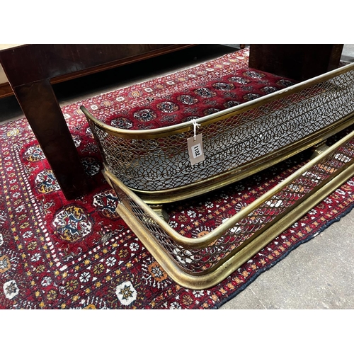 1102 - Two Victorian pierced brass fenders, larger width 123cm