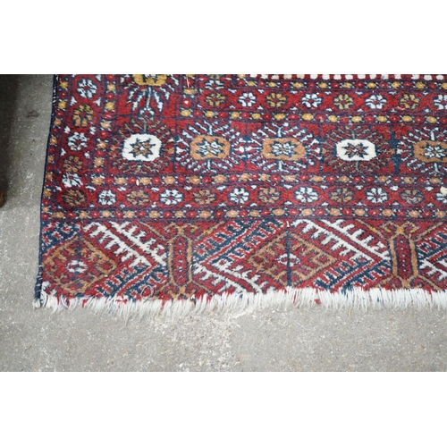 1103 - A Bokhara red ground rug, 186 x 122cm