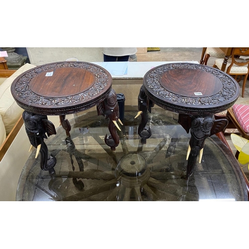 1105 - A pair of Indian circular carved hardwood elephant occasional tables, diameter 45cm, height 48cm... 