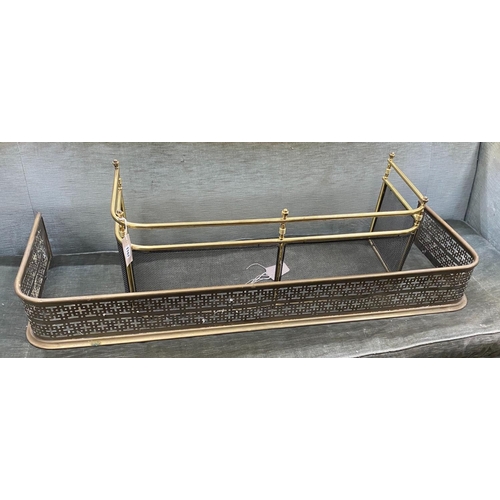 1107 - A Victorian pierced brass fender, length 121cm together with a smaller reproduction brass fender... 