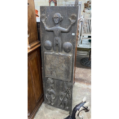 1137 - An African carved hardwood door, width 52cm, height 156cm