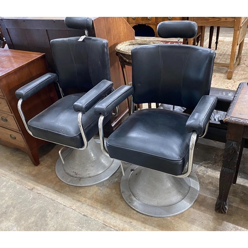 1145 - A pair of mid century black leatherette and chrome adjustable barber's chairs, width 62cm