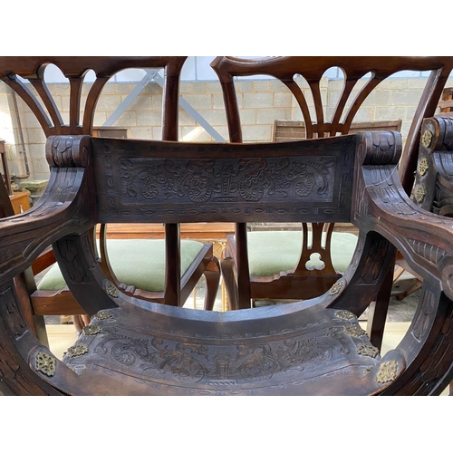 1153 - A pair of 19th century Spanish embossed leather and carved walnut framed 'X'  framed armchairs, widt... 