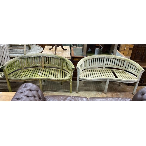 1161 - A pair of weathered teak 'banana' garden benches, length 158cm, depth 60cm, height 84cm (one with mi... 