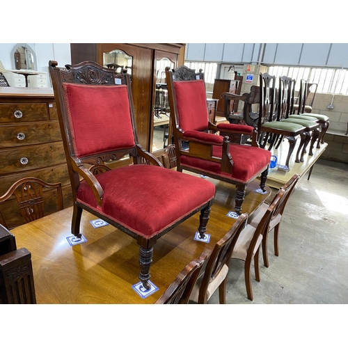 1164 - A pair of late Victorian carved mahogany upholstered salon chairs, one with arms, width 70cm, depth ... 