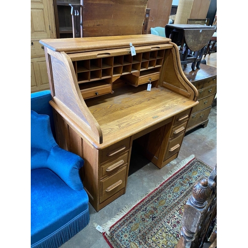 1208A - An early 20th century pale oak roll top desk, with 'S' shape tambour, width 121cm, depth 77cm, heigh... 