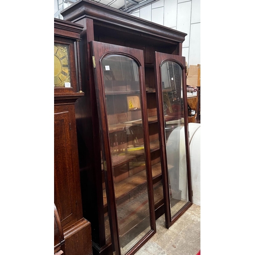 1211 - A large mahogany bookcase with two glazed panel doors, width 138cm, depth 31cm, height 209cm