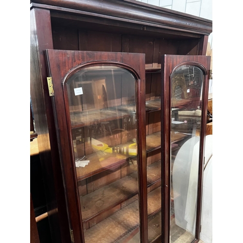 1211 - A large mahogany bookcase with two glazed panel doors, width 138cm, depth 31cm, height 209cm