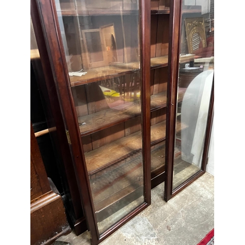 1211 - A large mahogany bookcase with two glazed panel doors, width 138cm, depth 31cm, height 209cm