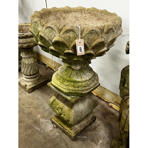 1215 - A reconstituted stone circular garden planter on square plinth, diameter 52cm, height 89cm