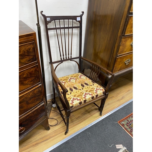 1226 - In the style of Charles Rene Mackintosh, an Edwardian mahogany elbow chair with upholstered drop-in ... 